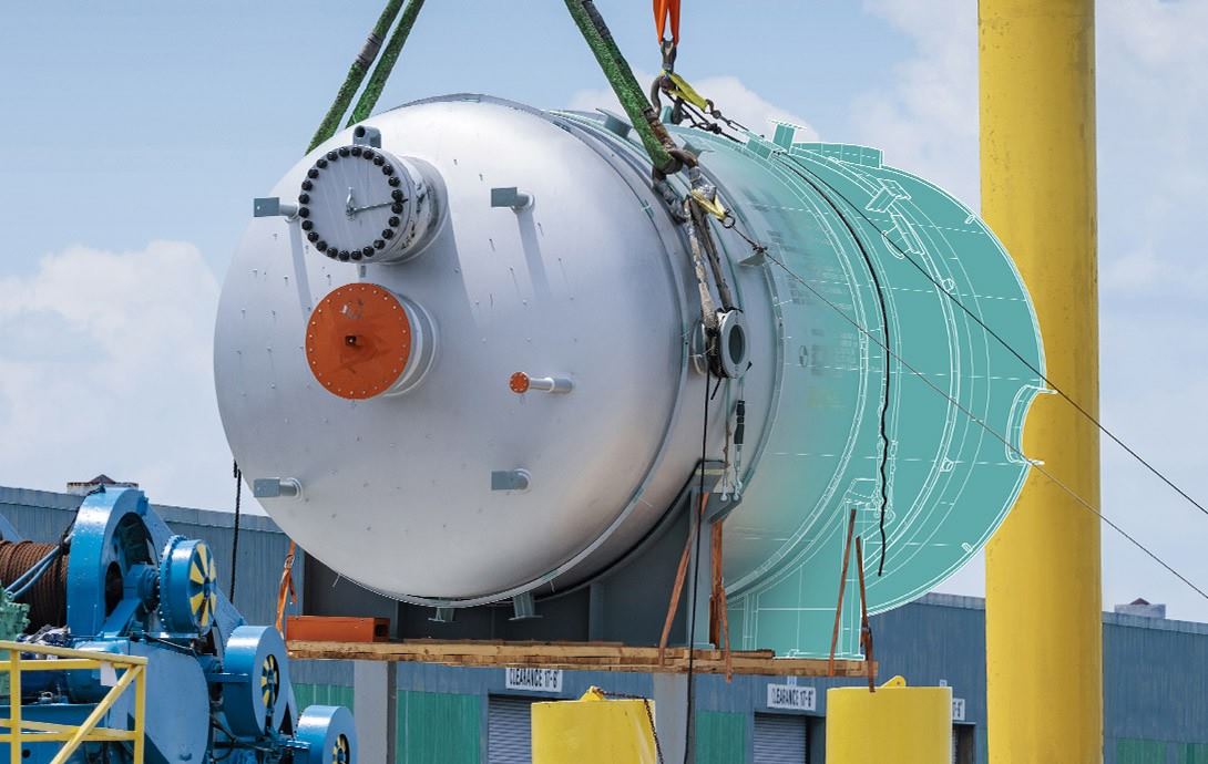 Large industrial cylinder or reactor vessel being hoisted by heavy-duty cranes