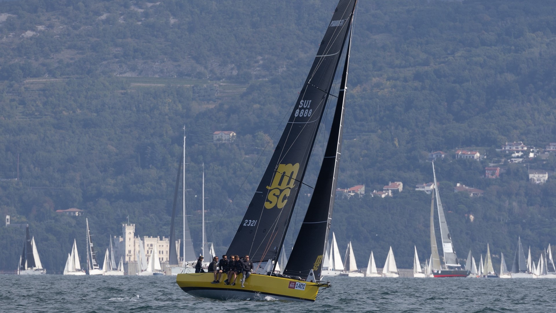 The MSC Sailing Team sitting on the boat while sailing.