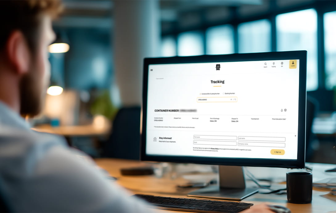 man siiting in front of a computer looking at the screen